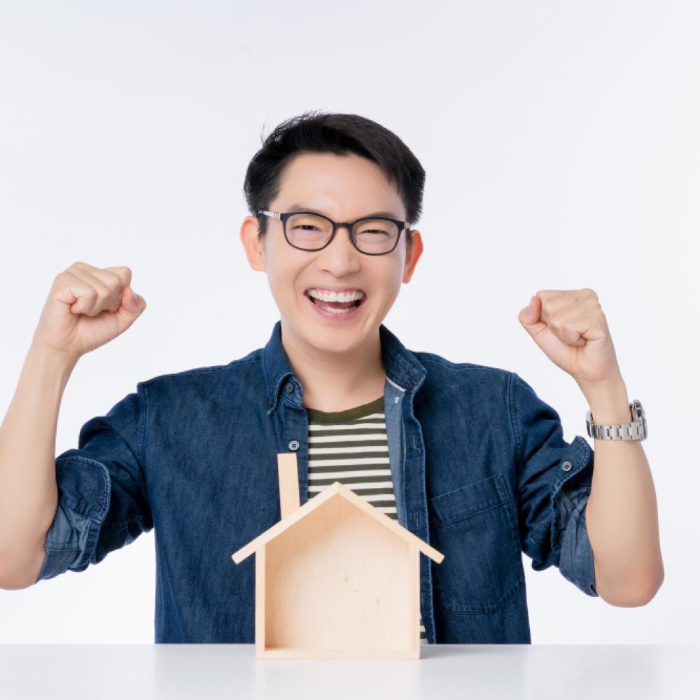 happy-asian-male-casual-lifestyle-smile-laugh-hand-rise-up-with-house-model-table-exiting-asian-man-with-big-success-promotion-business-ideas-concept